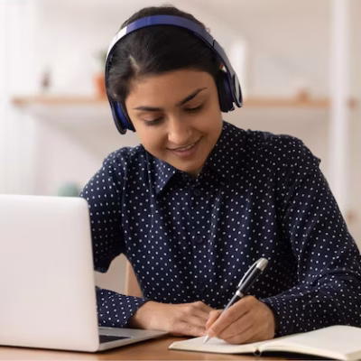 remote-student-focused-young-indian-lady-wearing-headphones-practice-distant-learning-english-language-write-test-before-pc-screen-hindu-woman-earphones-listen-webinar-online-take-notes_774935-1471